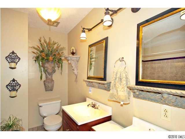 2219 Long Hope Road Monroe, NC 28112 - Photo 12 of 16 a bathroom with a tub sink and mirror