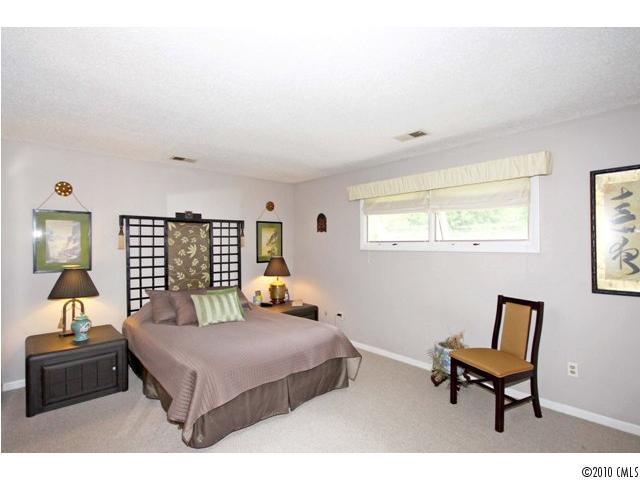 2219 Long Hope Road Monroe, NC 28112 - Photo 16 of 16 a bedroom with a bed and wooden floor