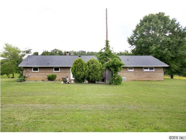 2219 Long Hope Road Monroe, NC 28112 - Photo 3 of 16 a front view of a house with a garden