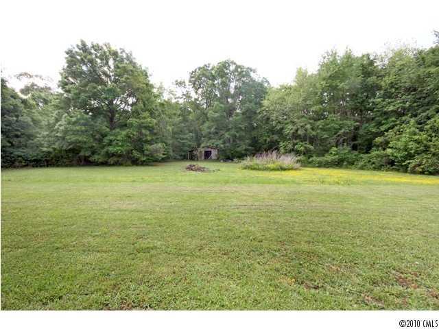 2219 Long Hope Road Monroe, NC 28112 - Photo 4 of 16 a view of a field with an trees in the background