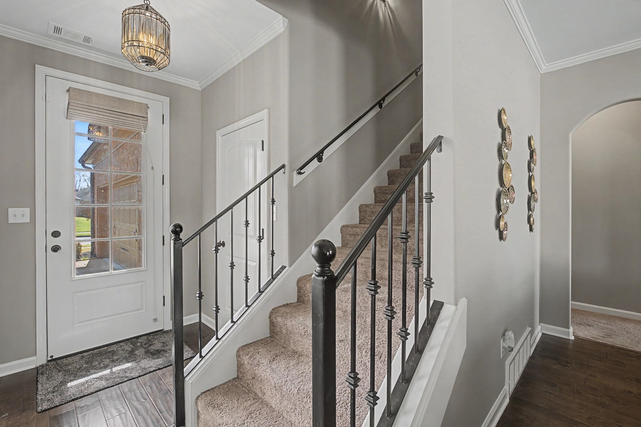 12436 Dusty Field Road Arlington, TN 38002 - Photo 25 of 40 Foyer featuring dark wood-style flooring, arched walkways, and crown molding