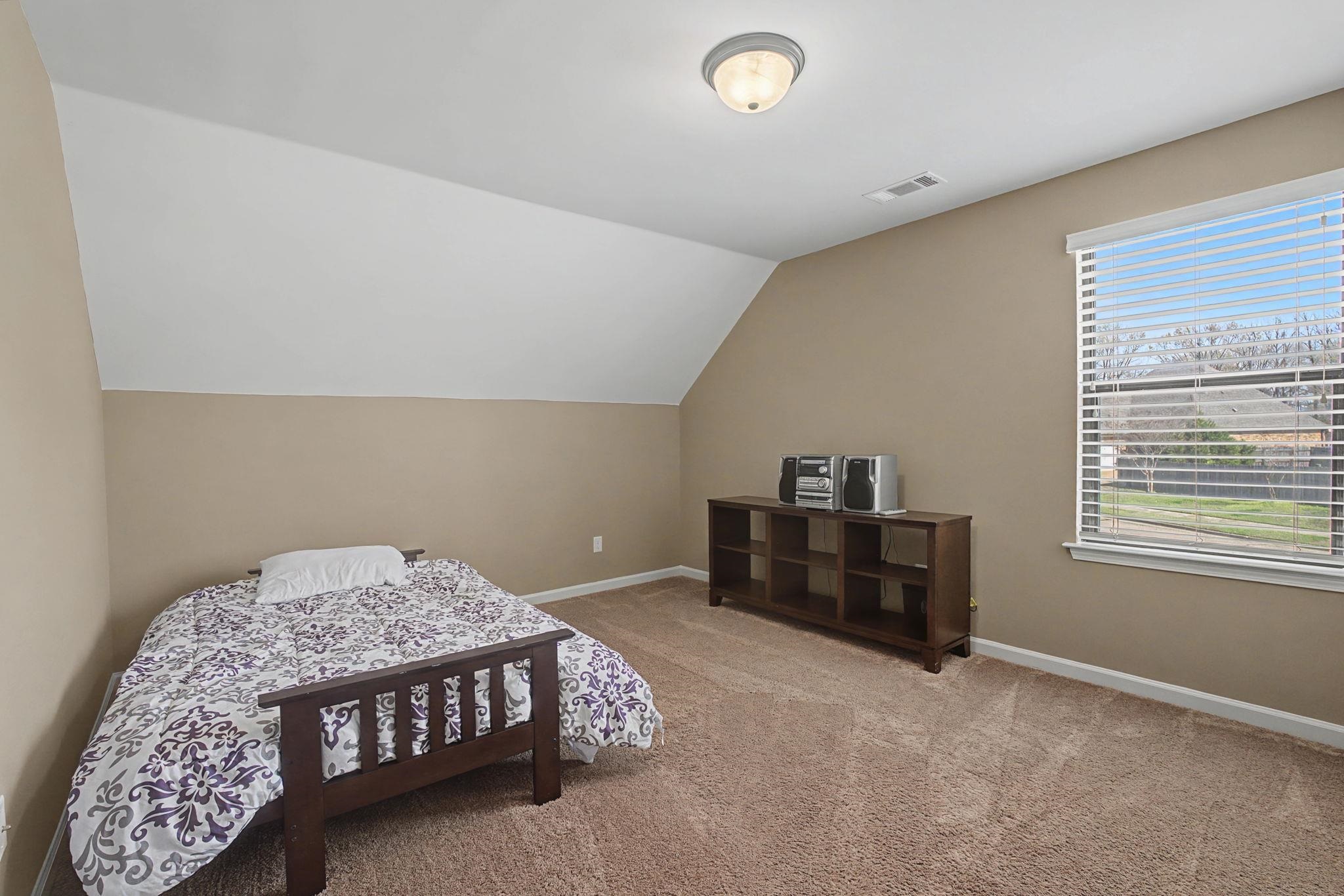 12436 Dusty Field Road Arlington, TN 38002 - Photo 28 of 40 Bedroom featuring vaulted ceiling and light colored carpet