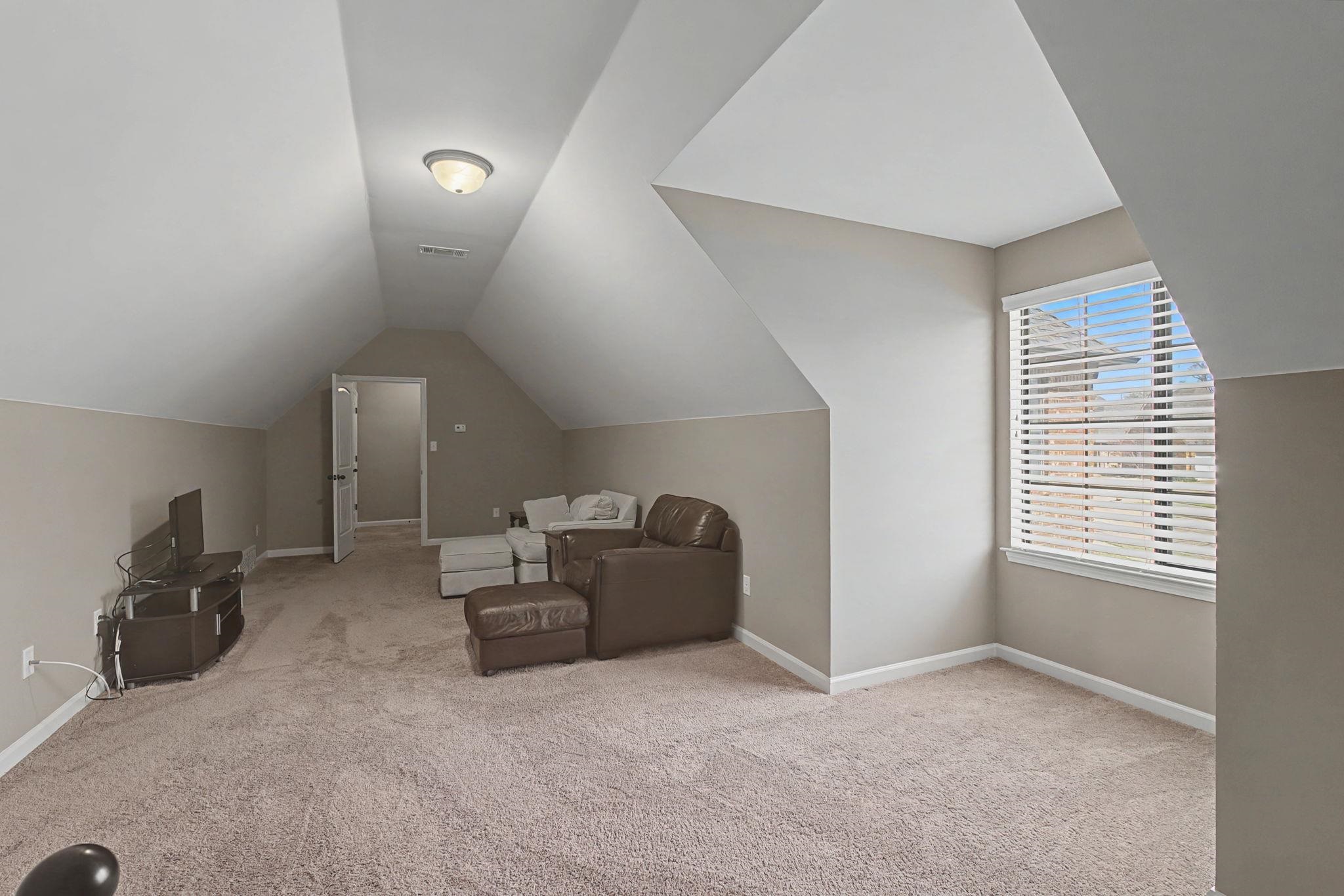 12436 Dusty Field Road Arlington, TN 38002 - Photo 30 of 40 Bonus room featuring light colored carpet and lofted ceiling