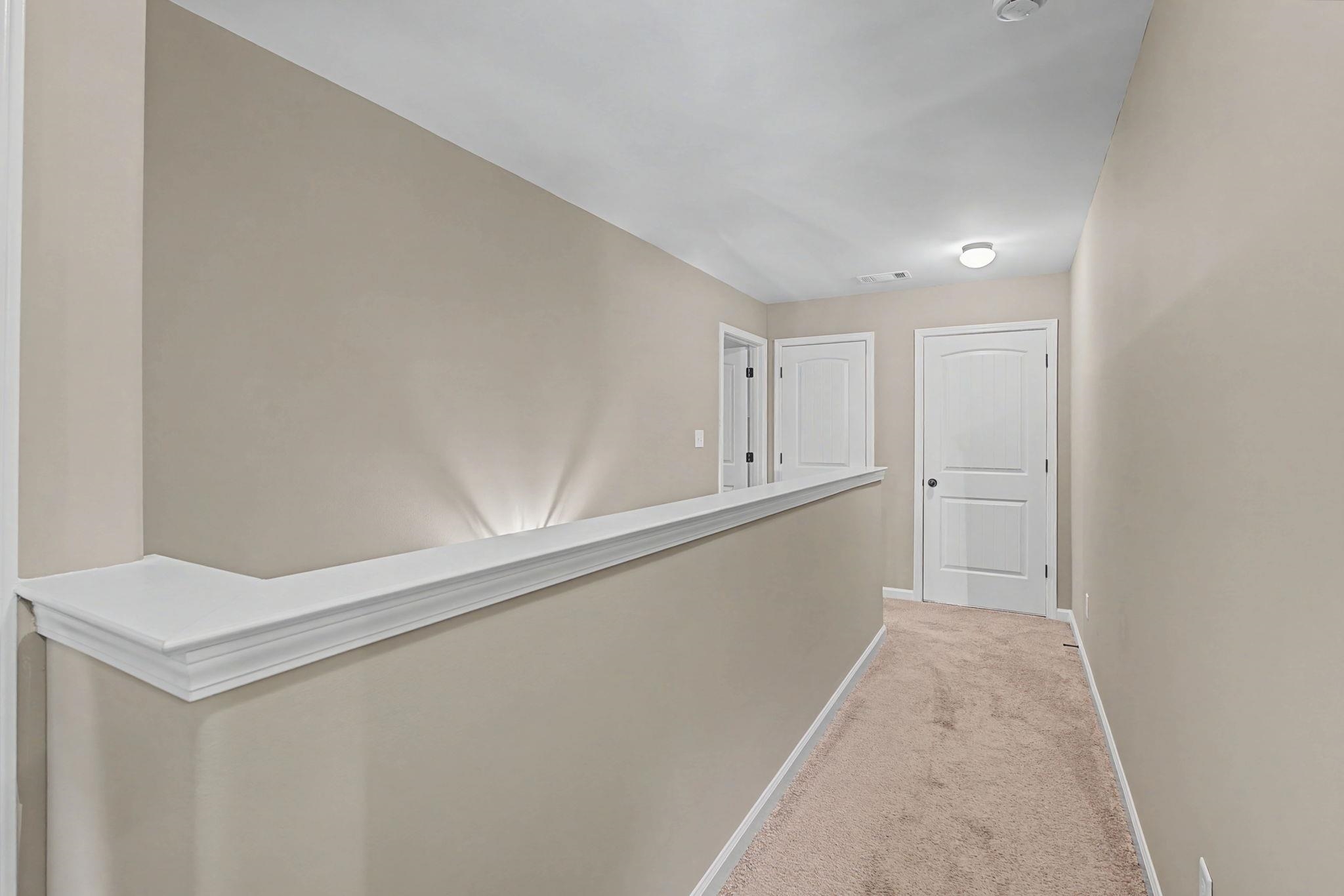 12436 Dusty Field Road Arlington, TN 38002 - Photo 32 of 40 Corridor with light colored carpet and baseboards