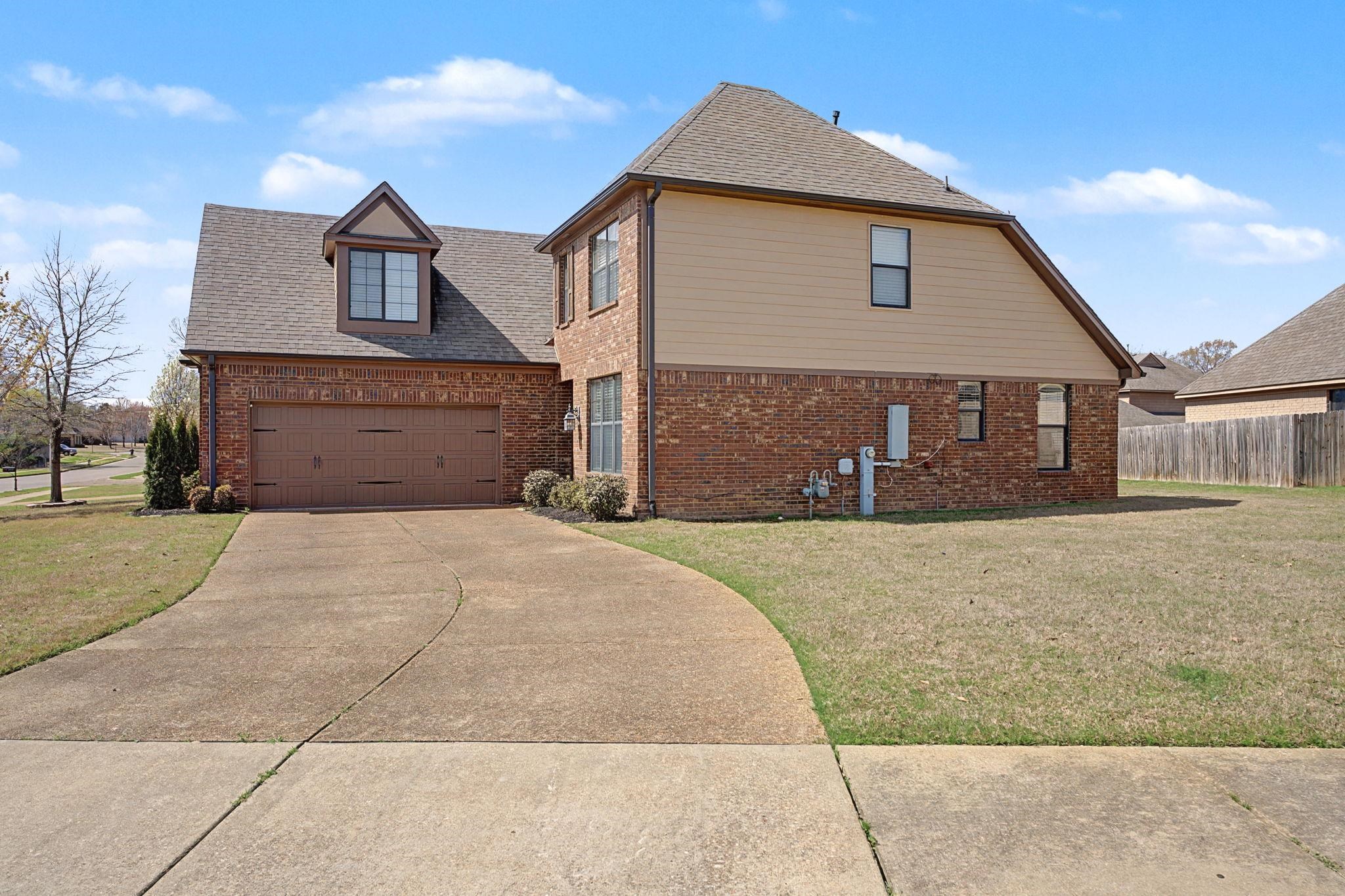 12436 Dusty Field Road Arlington, TN 38002 - Photo 4 of 40 View of home's exterior with brick siding, roof with shingles, driveway, and a garage