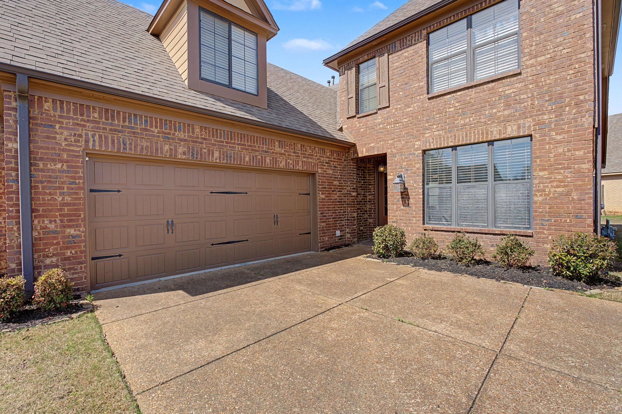 12436 Dusty Field Road Arlington, TN 38002 - Photo 5 of 40 View of front of home with roof with shingles, a garage, concrete driveway, and brick siding