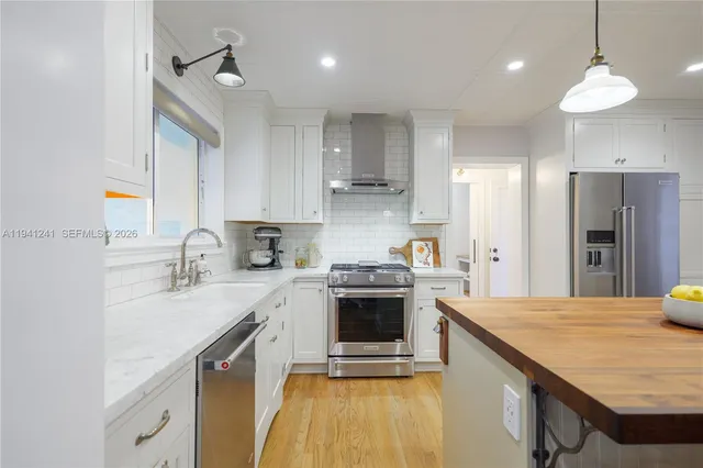 a kitchen with a sink stove and refrigerator