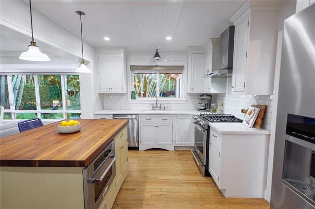 a kitchen with stainless steel appliances granite countertop a sink and a stove