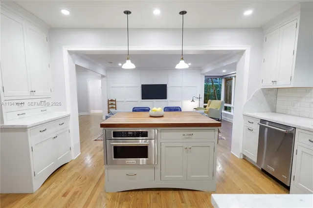 a kitchen with a stove oven and white cabinets