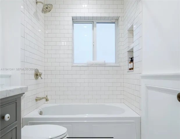 a bathroom with toilet bathtub and shower