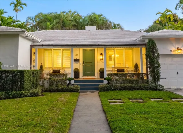a view of swimming pool with lawn chairs under an umbrella