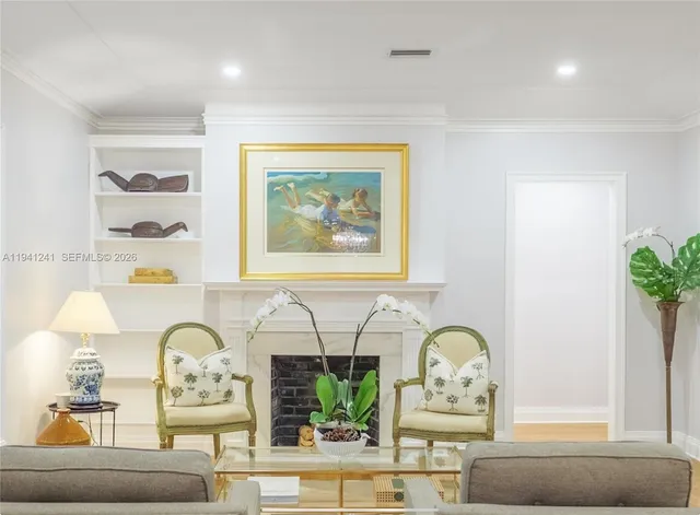 a living room with furniture and potted plant