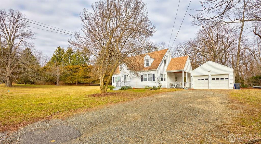 165 Pond Road Freehold, NJ 07728 - Photo 3 of 43 a front view of a house with a yard and trees