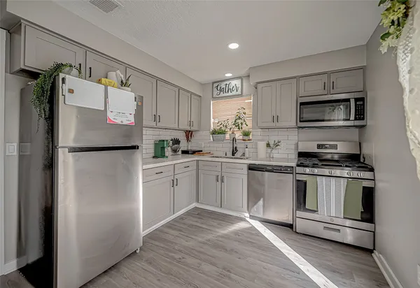 a kitchen with a refrigerator stove and microwave