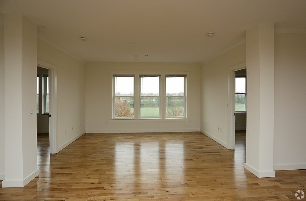 87 New Street, Unit 204 Cambridge, MA 02138 - Photo 4 of 14 a view of empty room with wooden floor and fan