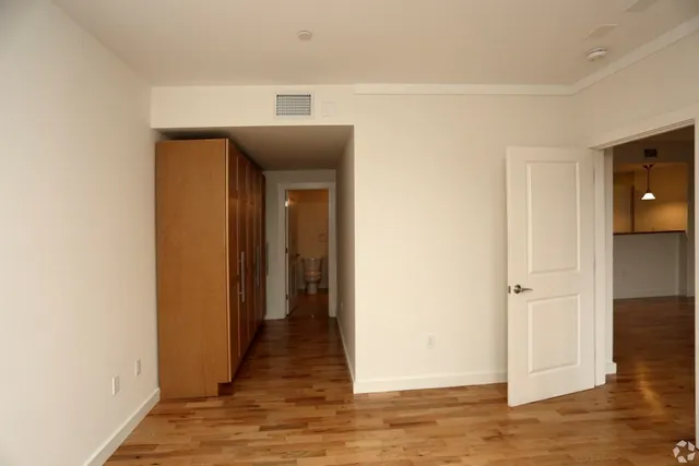 a view of hallway with wooden floor