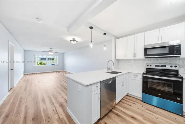 a kitchen with a sink and a stove top oven