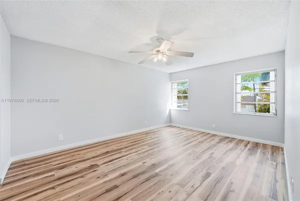 a bedroom with a large bed a chandelier and a dresser