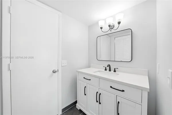 a view of a room with wooden floor and a ceiling fan