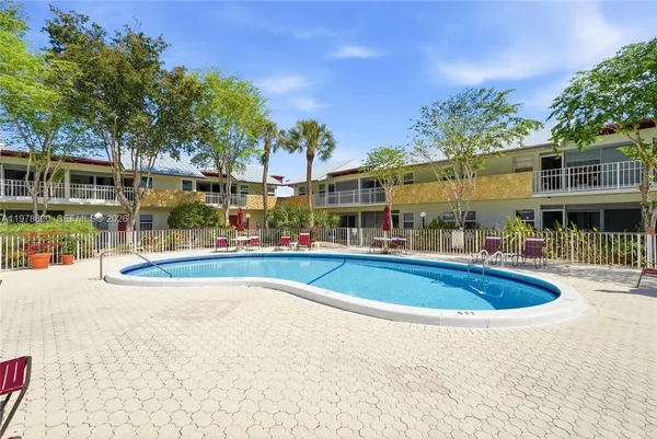 an aerial view of residential houses with outdoor space and swimming pool