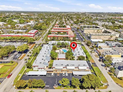 an aerial view of residential building with parking