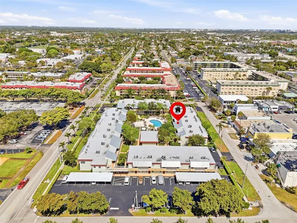 an aerial view of residential building with parking