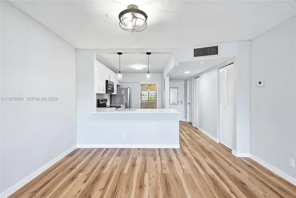 a kitchen with stainless steel appliances a stove a refrigerator and a sink