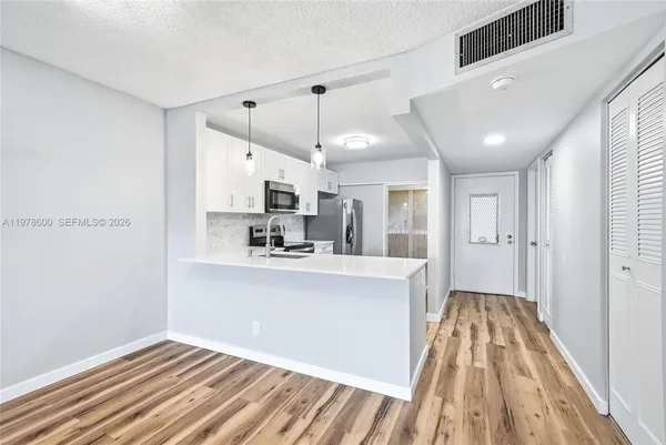 a kitchen with a sink stove and microwave