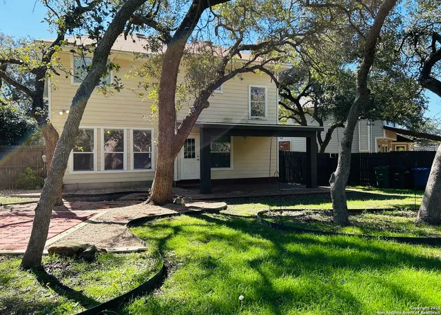 a view of a backyard with a table and chairs