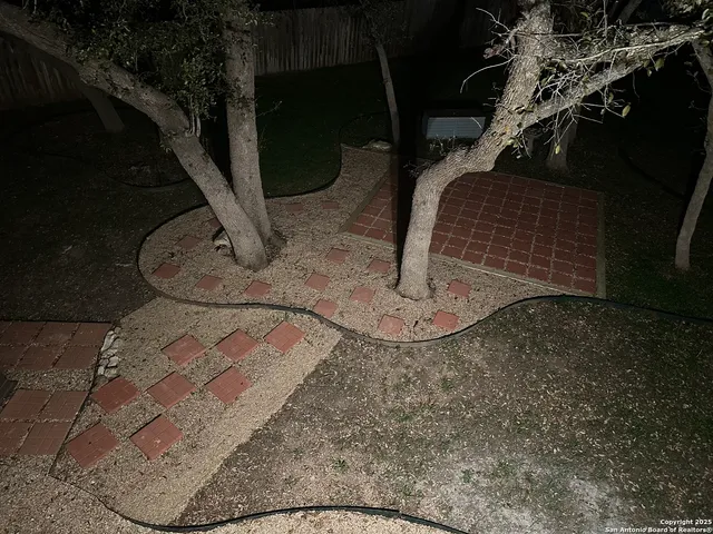 a wooden bench sitting in the middle of a yard