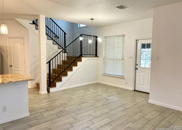 a view of an entryway with wooden floor