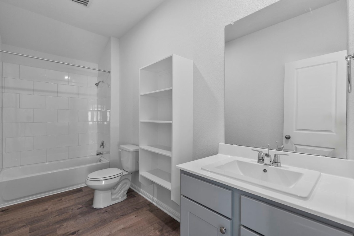 125 Hatari Trail Jarrell, TX 76537 - Photo 14 of 40 a bathroom with a sink toilet and shower