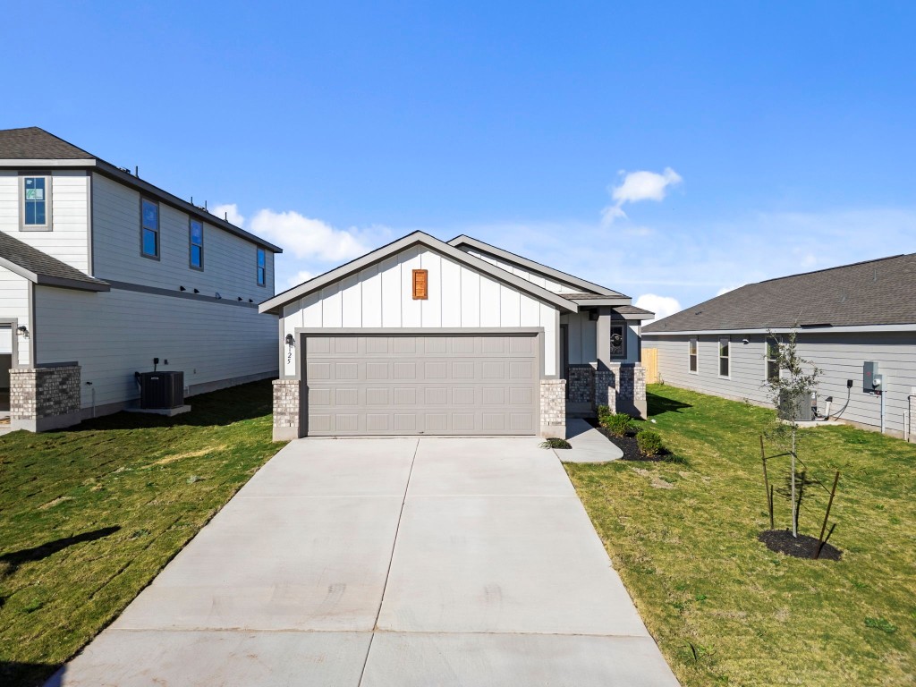 125 Hatari Trail Jarrell, TX 76537 - Photo 29 of 40 a front view of a house with garden