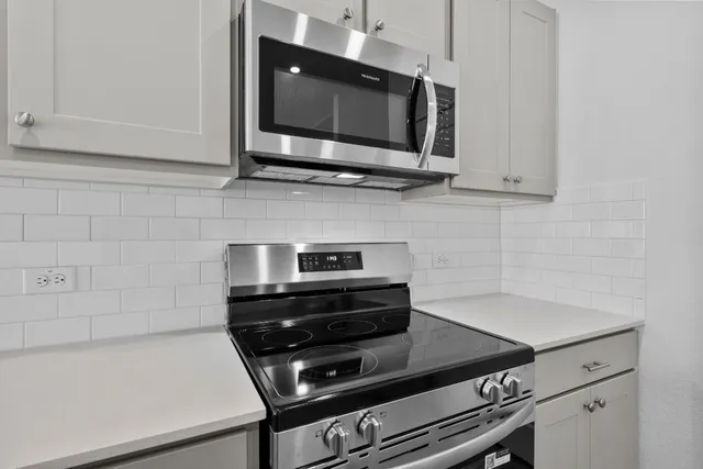 a kitchen with a stove and a microwave
