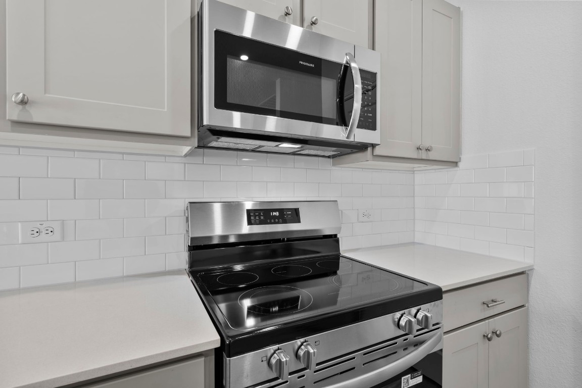 125 Hatari Trail Jarrell, TX 76537 - Photo 5 of 40 a kitchen with a stove and a microwave