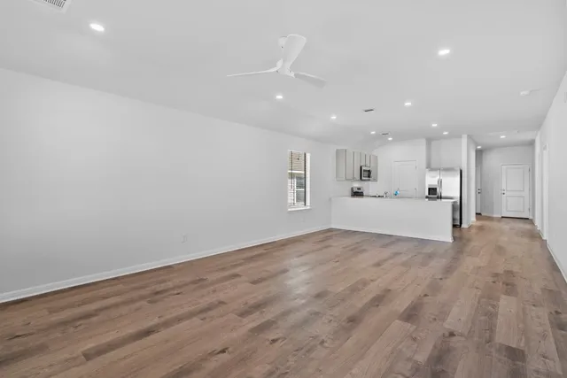 a view of a kitchen with a sink stainless steel appliances and cabinets