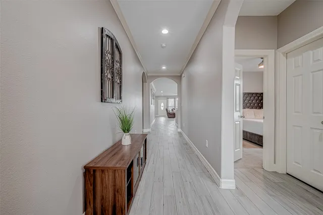 a hallway with wooden floor seating and livingroom