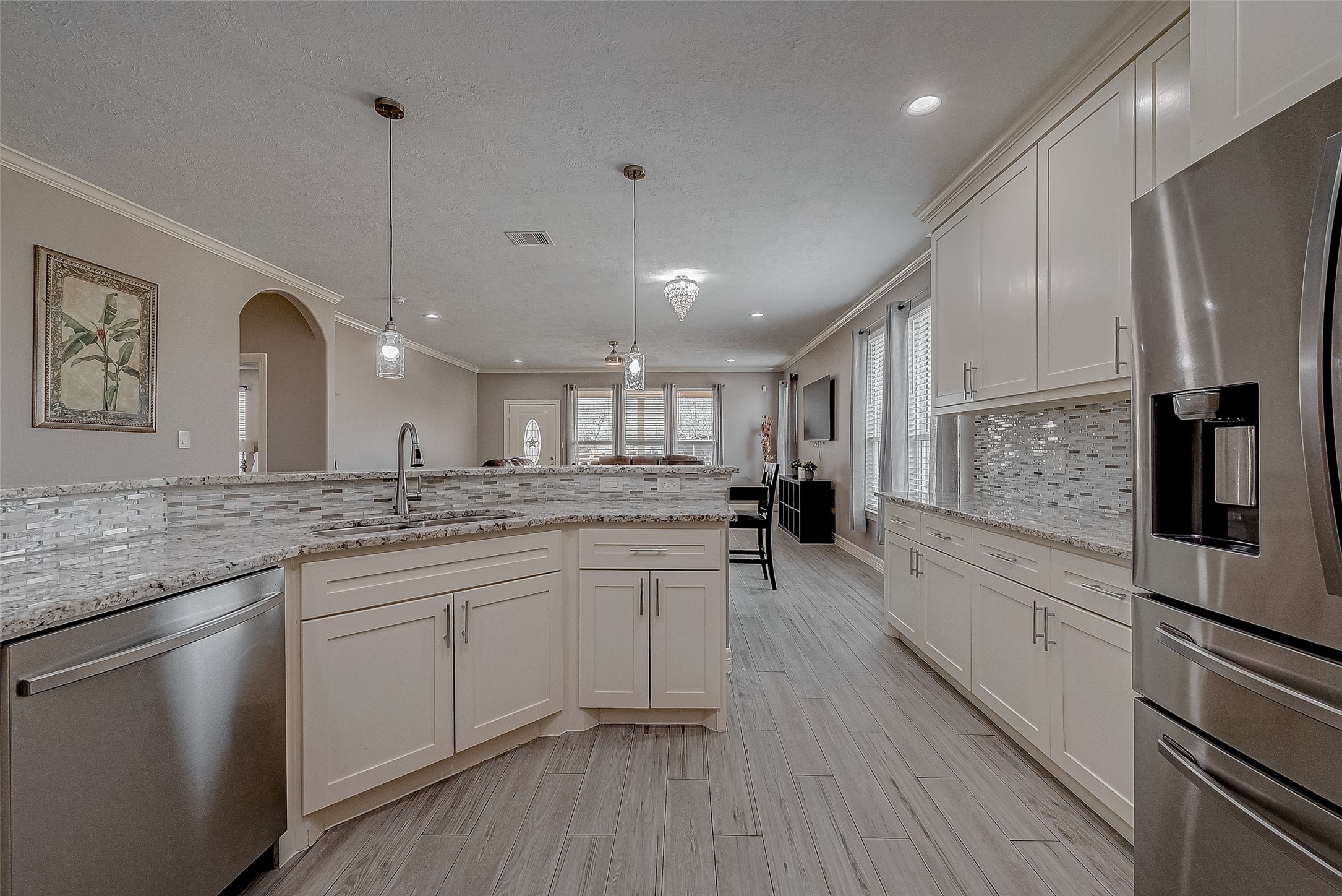 709 Coen Road Rosharon, TX 77583 - Photo 16 of 33 a kitchen with stainless steel appliances granite countertop a sink a stove a refrigerator and island with wooden floor