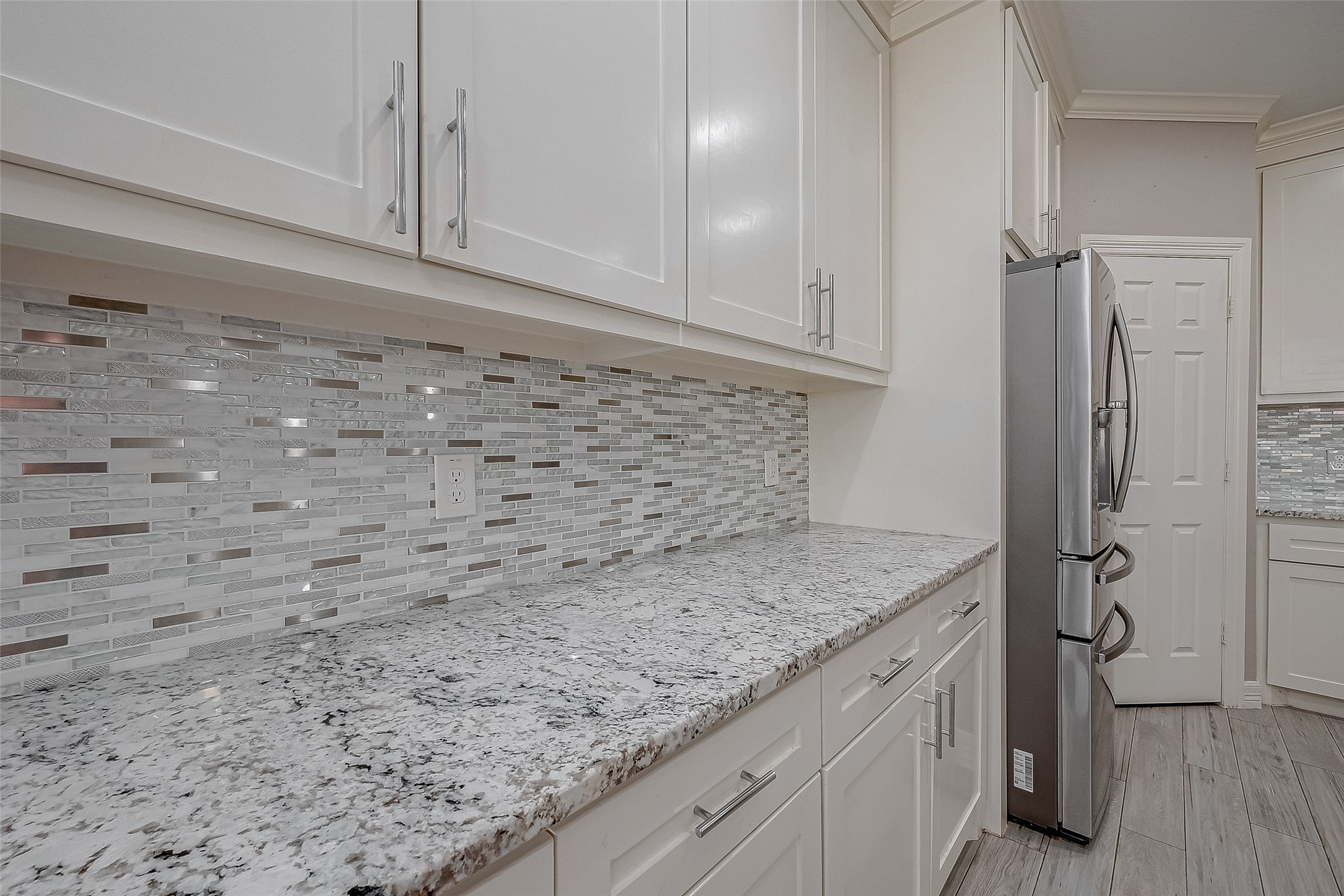 709 Coen Road Rosharon, TX 77583 - Photo 19 of 33 a kitchen with a granite countertop sink and cabinets