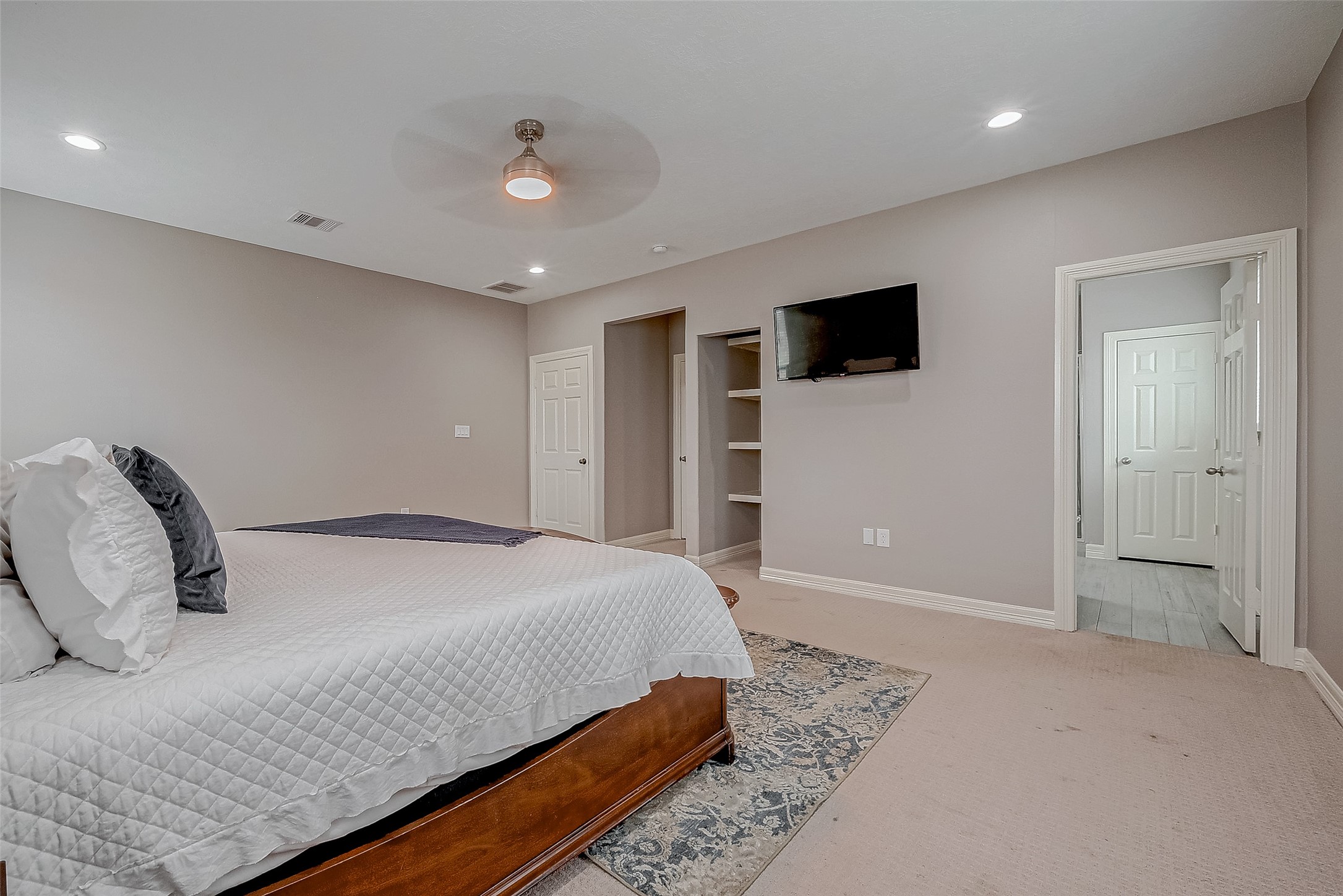 709 Coen Road Rosharon, TX 77583 - Photo 22 of 33 a bedroom with a large bed and a flat screen tv
