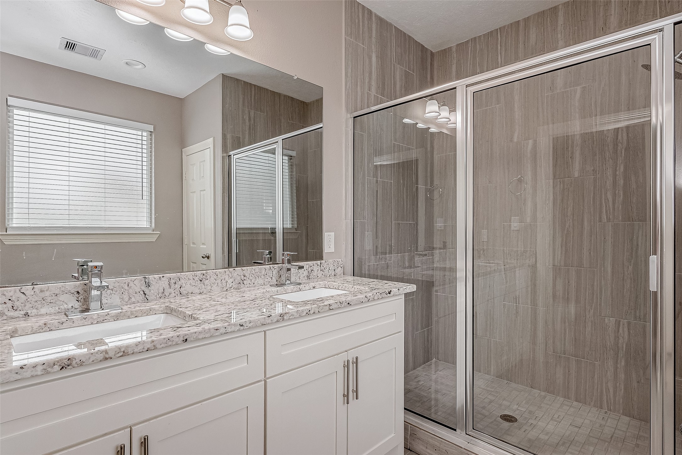 709 Coen Road Rosharon, TX 77583 - Photo 24 of 33 a bathroom with a granite countertop sink a mirror and shower