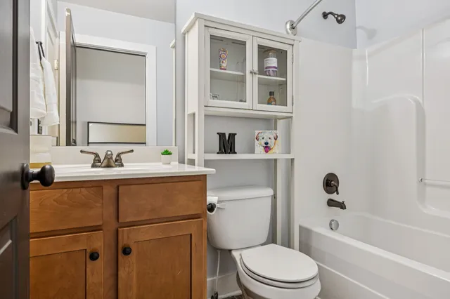 a bedroom with a bed dresser and a window
