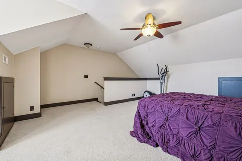 a bedroom with a bed and a ceiling fan