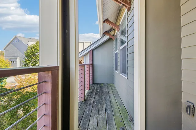 a view of a balcony with wooden floor
