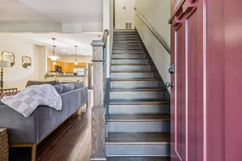a living room with furniture a flat screen tv and a fireplace