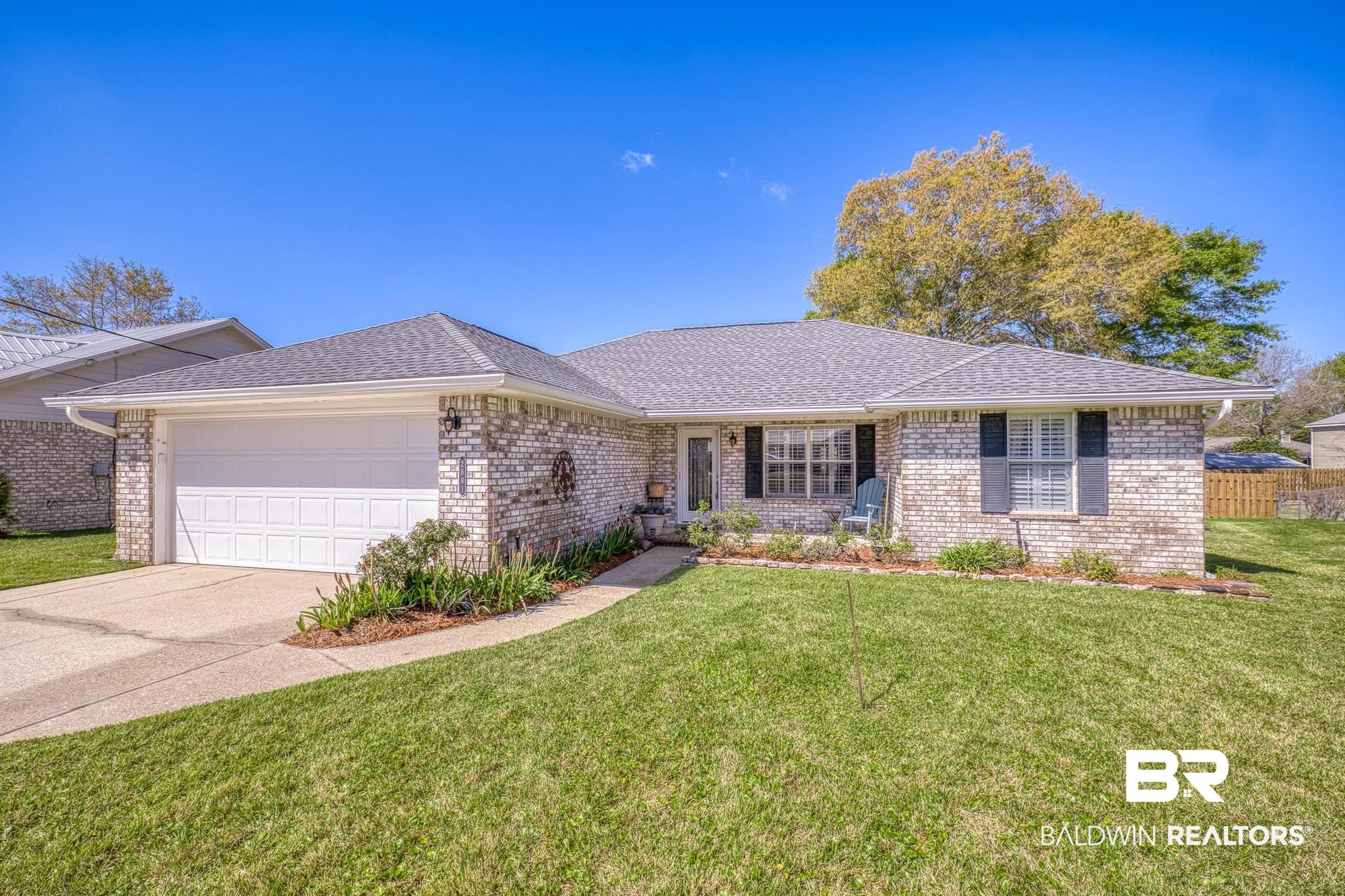 2881 Eslava Circle Lillian, AL 36549 - Photo 26 of 58 Ranch-style home featuring a garage, roof with shingles, brick siding, and driveway