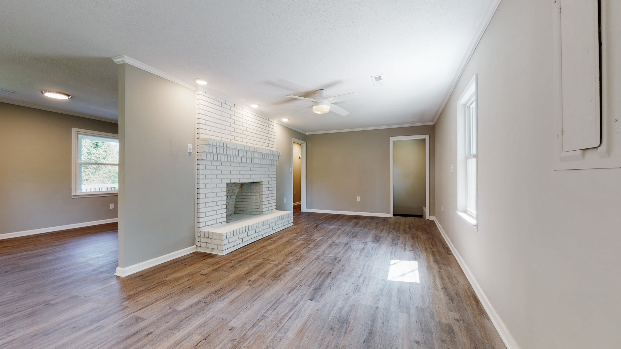 28 Providence Road Fayetteville, TN 37334 - Photo 9 of 48 an empty room with wooden floor and fireplace