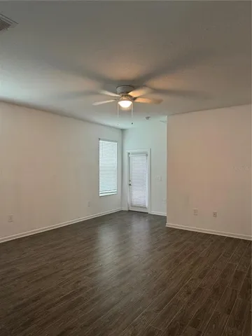a view of an empty room and wooden floor