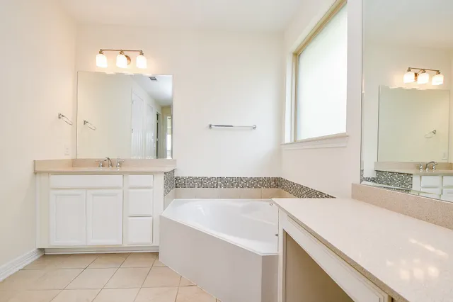 a bathroom with a sink vanity and a mirror