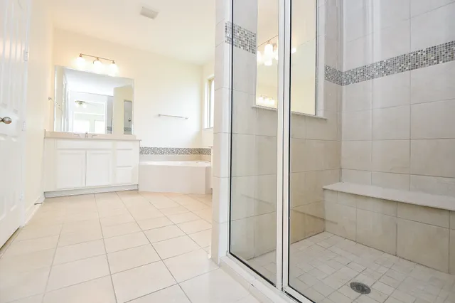 a bathroom with a bathtub and a shower